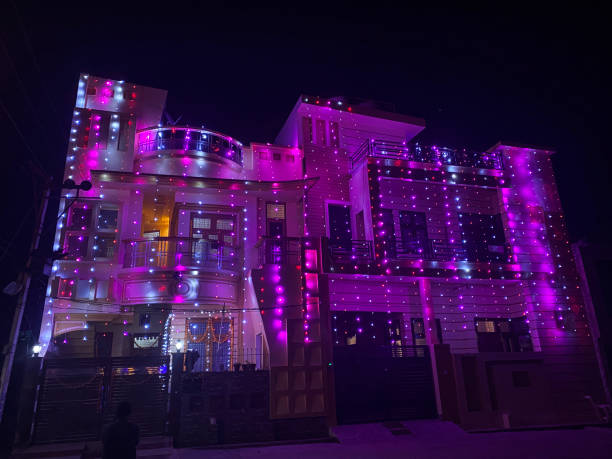 Image of house decorated with white and pink fairy lights for Indian traditional festival of lights stock photo