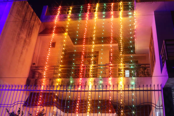Image of house balcony decorated with multicolour fairy lights for Indian traditional festival of lights, bokeh stock photo