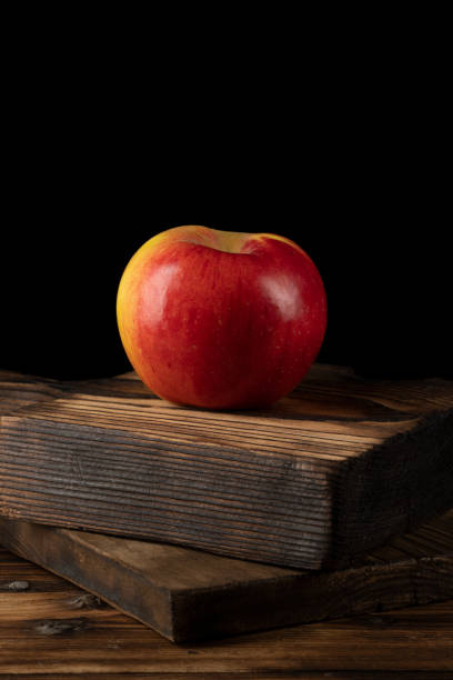 istock Fresh red apples on wooden table. On wooden background. 1352905925