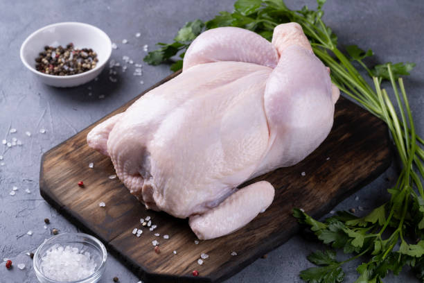 istock whole raw chicken on a wooden board 1352905947