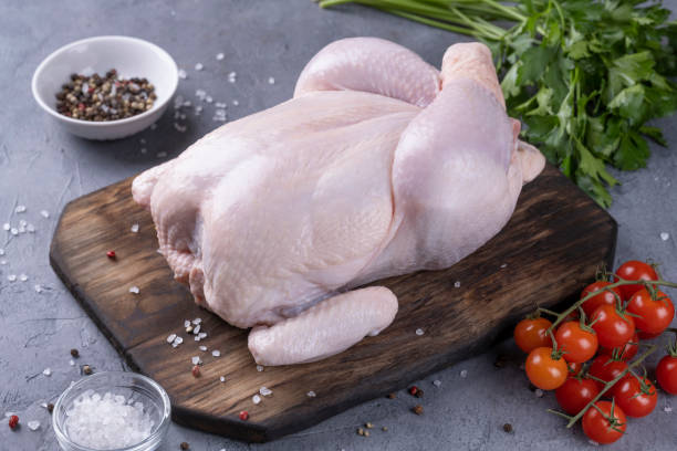 istock whole raw chicken on a wooden board 1352905950