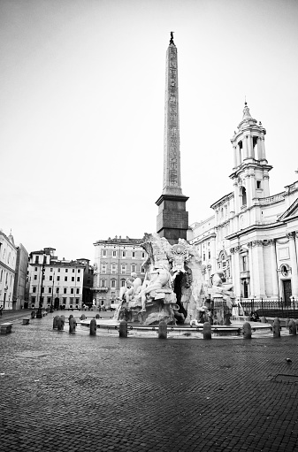 Fountain of the Four Rivers by Bernini in 1651, Egyptian obelisk and Sant Agnese Church on the famous Piazza Navona, Rome, Italy.
