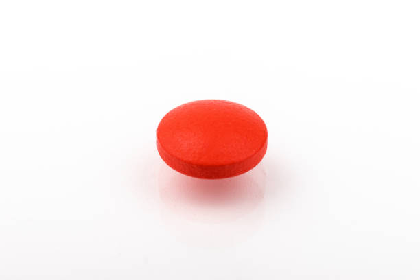 istock Red pills on a white background, isolated. Pharmacy. Treatment. 1352906513