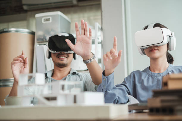 Architect wearing virtual reality headset for detail project house model. stock photo