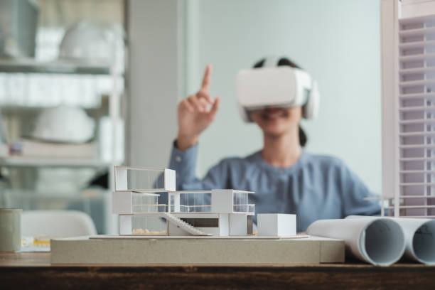 istock Architect wearing virtual reality headset for detail project house model. 1352906590