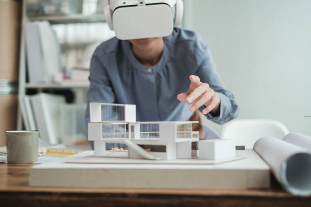 istock Architect wearing virtual reality headset for detail project house model. 1352906629