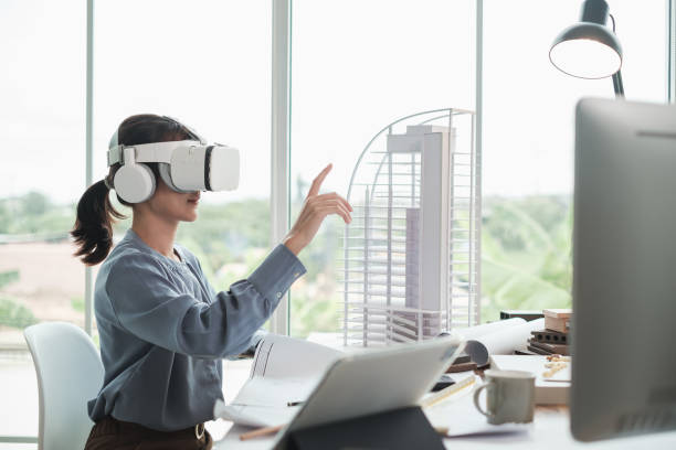Architect wearing virtual reality headset for detail project house model. Technology futuristic virtual reality design. Architect or Engineer female wearing VR headset in office. building information modeling photos stock pictures, royalty-free photos & images