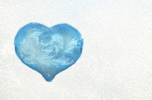 Heart on a frozen window stock photo
