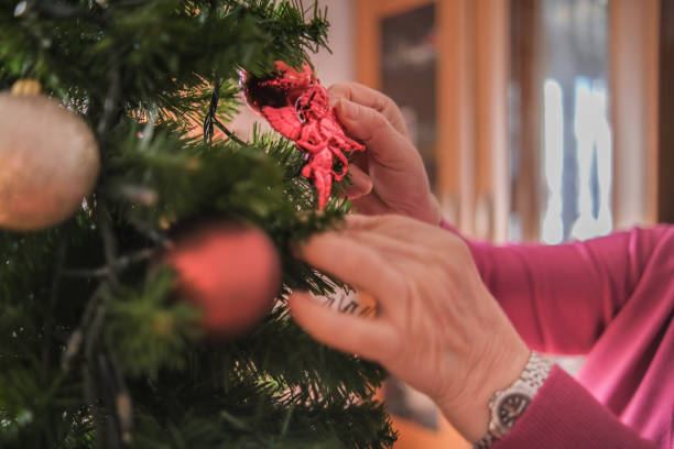 istock Grandmother decorating the Christmas tree 1352909316