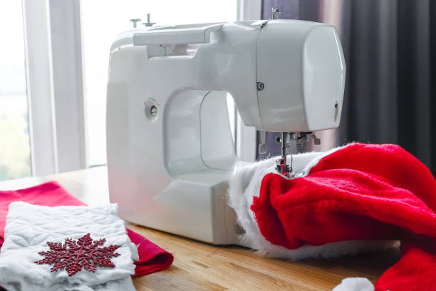 istock Christmas,Handmade Sewing.Recycling Handmade DIY hand home.sewing machine project lockdown. home sewing,Hobby, meditation,zero waste,recycling. Girl sews clothes home sewing machine,ecology zero waste 1352914872