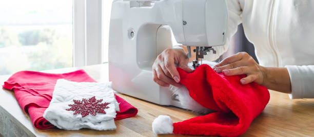 istock Christmas,Handmade Sewing.Recycling Handmade DIY hand home.sewing machine project lockdown. home sewing,Hobby, meditation,zero waste,recycling. Girl sews clothes home sewing machine,ecology zero waste 1352915040