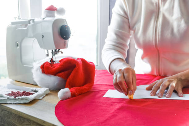 istock Christmas,Handmade Sewing.Recycling Handmade DIY hand home.sewing machine project lockdown. home sewing,Hobby, meditation,zero waste,recycling. Girl sews clothes home sewing machine,ecology zero waste 1352915947