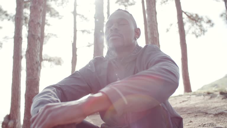 4k video footage of a man taking a deep breath while out in nature