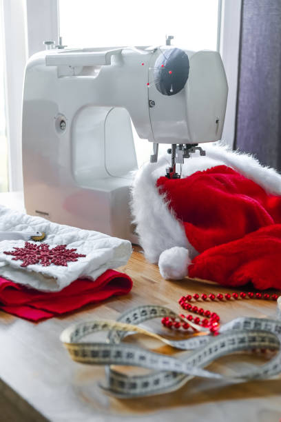 istock Christmas,Handmade Sewing.Recycling Handmade DIY hand home.sewing machine project lockdown. home sewing,Hobby, meditation,zero waste,recycling. Girl sews clothes home sewing machine,ecology zero waste 1352916324
