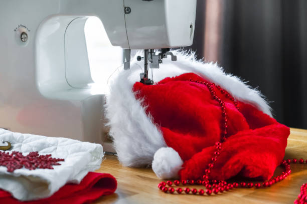 istock Christmas,Handmade Sewing.Recycling Handmade DIY hand home.sewing machine project lockdown. home sewing,Hobby, meditation,zero waste,recycling. Girl sews clothes home sewing machine,ecology zero waste 1352916424