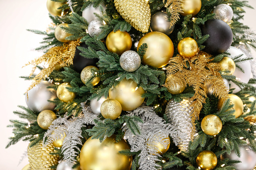 Decorated Christmas tree with silver, gold and black ornaments