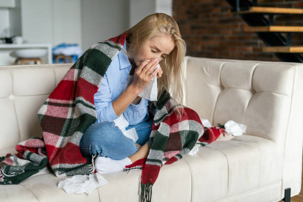 istock Ill and young woman sneeze in tissue 1352919026