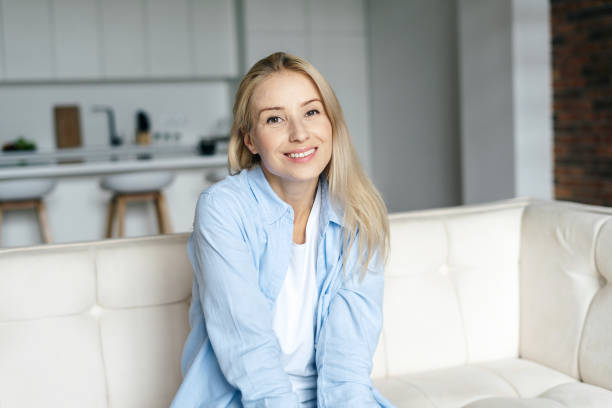 istock Happy young woman looking at camera, smiling wide 1352919028