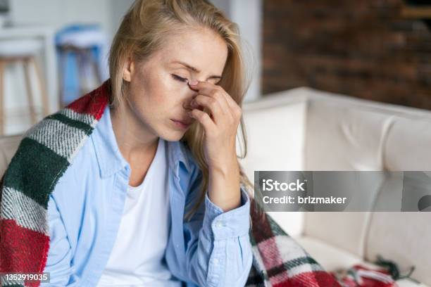 Tired Woman With Closed Eyes Touching Nose Bridge Stock Photo - Download Image Now - Tired, Illness, Exhaustion
