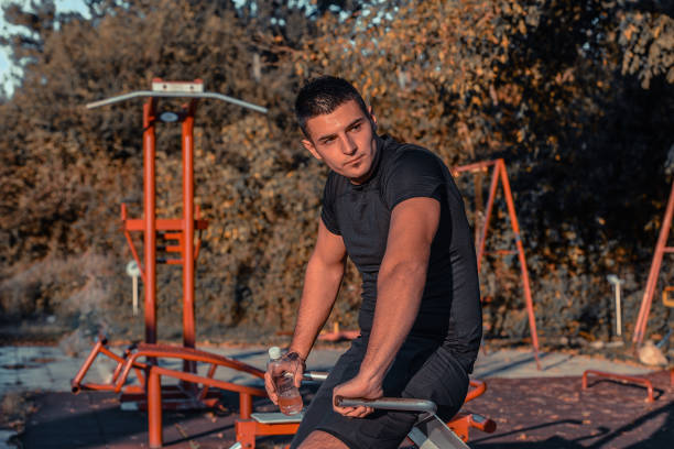 istock Handsome muscular man take break during gym training 1352923008