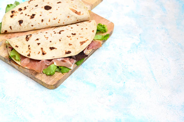 istock italian flatbread sandwich on a wooden cutting board close. 1352923804
