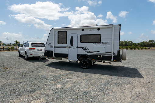 Proserpine, Queensland, Australia - November 2021: Car and caravan parked at coffee plantation to have a break on the journey