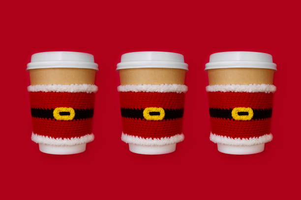 three paper beige cups with white lid dressed in santa claus clothes on red background three christmas paper beige cups with white lid dressed in santa claus clothes on red background, copy space christmas paper photos stock pictures, royalty-free photos & images