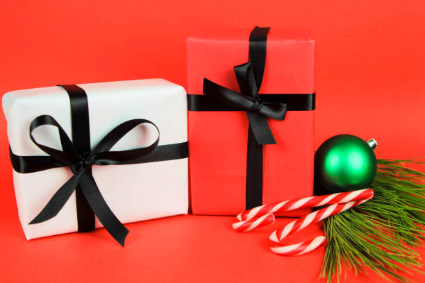 istock Gifts with Christmas decoration on red background 1352929921