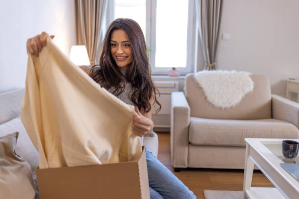 istock Young woman unpack the package she ordered online. 1352931125