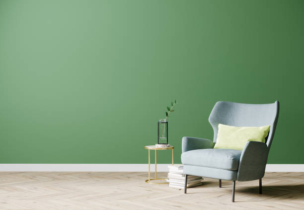 istock Empty bright modern living room with blue armchair and coffee table with decoration on empty green wall background, living room interior background, 3d rendering 1352931531