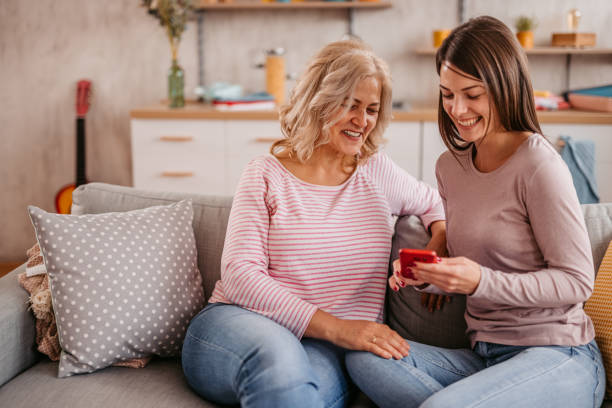 istock Daughter showing some content on phone to mother 1352932351