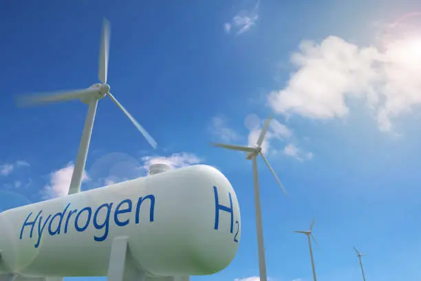Photo of Hydrogen tank and windmills on blue sky background. Sustainable and ecological energy concept. 3d illustration.