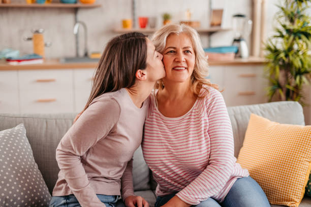 istock Daughter kissing her mother 1352932671