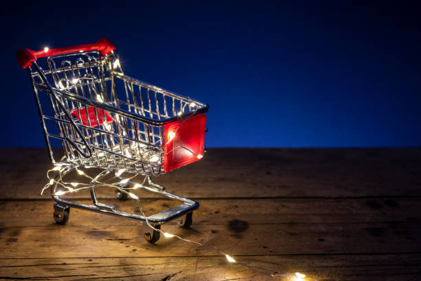 Shopping concept image with a shopping cart and christmas led lights stock photo