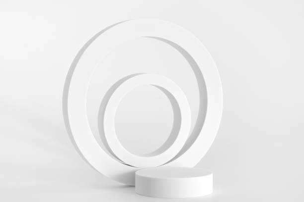 istock White podium on the white background, simple geometric forms. Podium for product, cosmetic presentation. Creative mock up. Pedestal or platform for beauty products. 1352932880