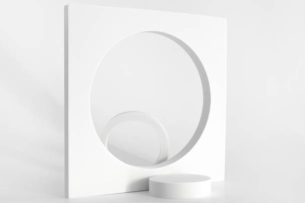 istock White podium on the white background, simple geometric forms. Podium for product, cosmetic presentation. Creative mock up. Pedestal or platform for beauty products. 1352932886