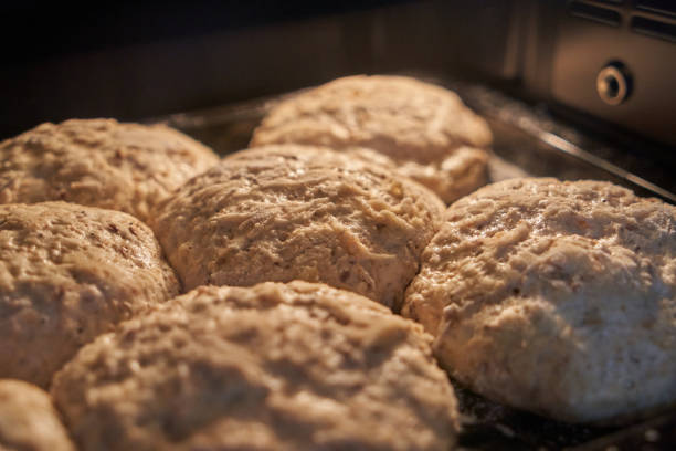 istock Small loaves of bread leavened on tin. Selective focus 1352934383