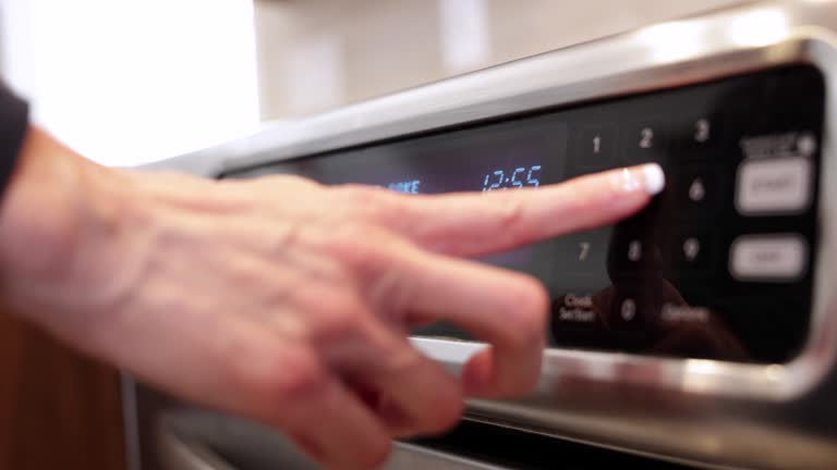 Close-up of Woman Hand Starting Kitchen Oven