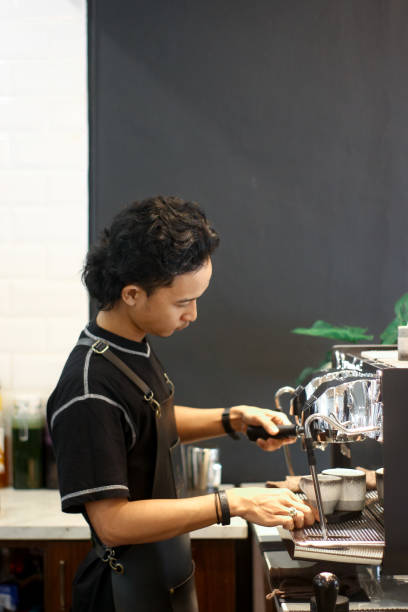 istock young men barista making coffee 1352936293