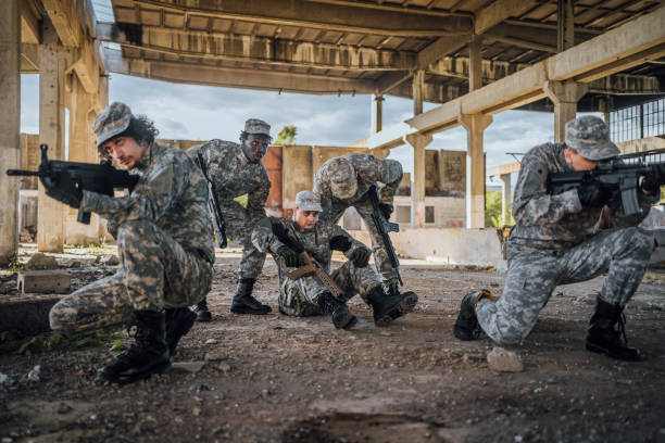 istock Military team extracting wounded soldier 1352937382