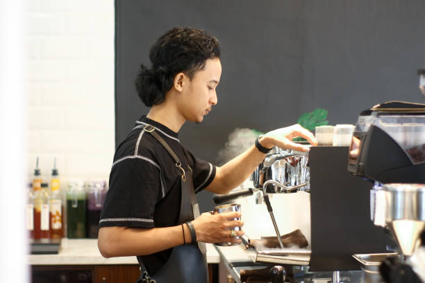istock young men barista making coffee 1352937517