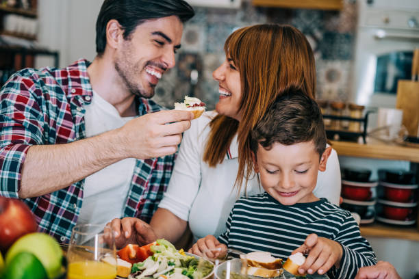 istock Young happy family having lunch at dining table. 1352937989