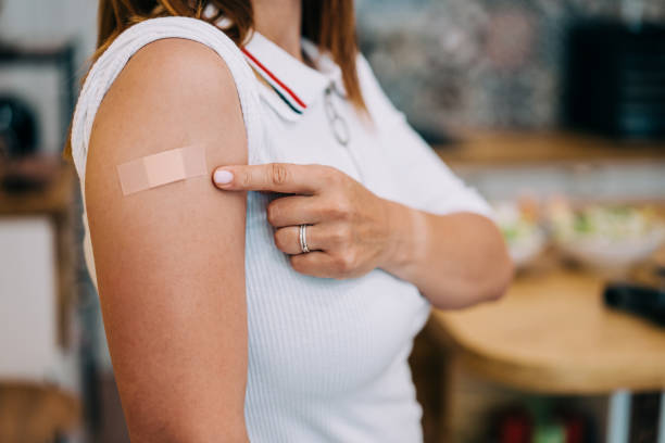 istock Woman showing her shoulder after getting vaccinated. 1352938040