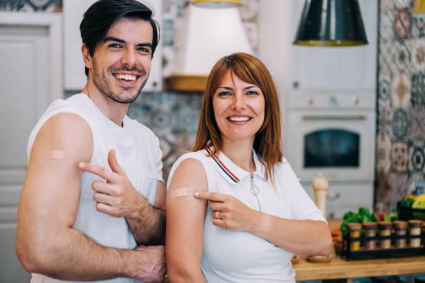 istock Couple showing their arms after getting vaccinated. 1352938044