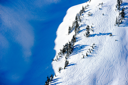 Ski tracks from heli skiing. Backcountry skiing tracks. Winter vacations.