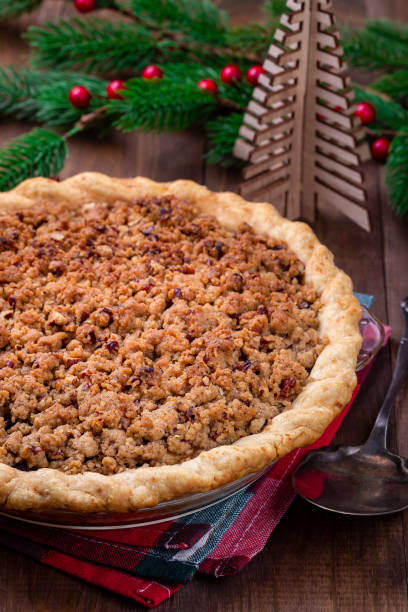 istock American apple cranberry pie, topped with crumbled dough and pecan, vertical 1352939283