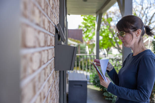 istock Woman Collecting Post at Home in her Mailbox in Australia 1352940632
