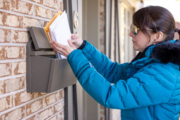 istock Woman Collecting Post at Home in her Mailbox in Australia 1352940802
