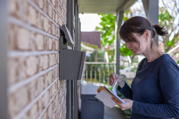 istock Woman Collecting Post at Home in her Mailbox in Australia 1352940978