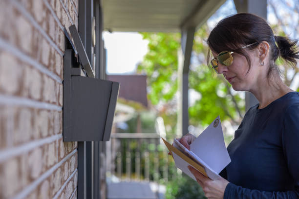 istock Woman Collecting Post at Home in her Mailbox in Australia 1352941009